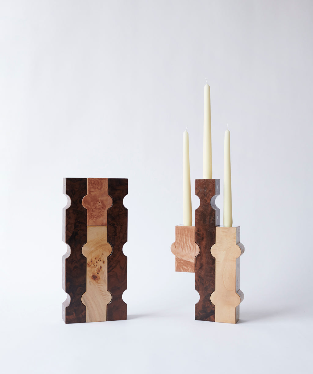 Sculptural wooden candle holders with white taper candles