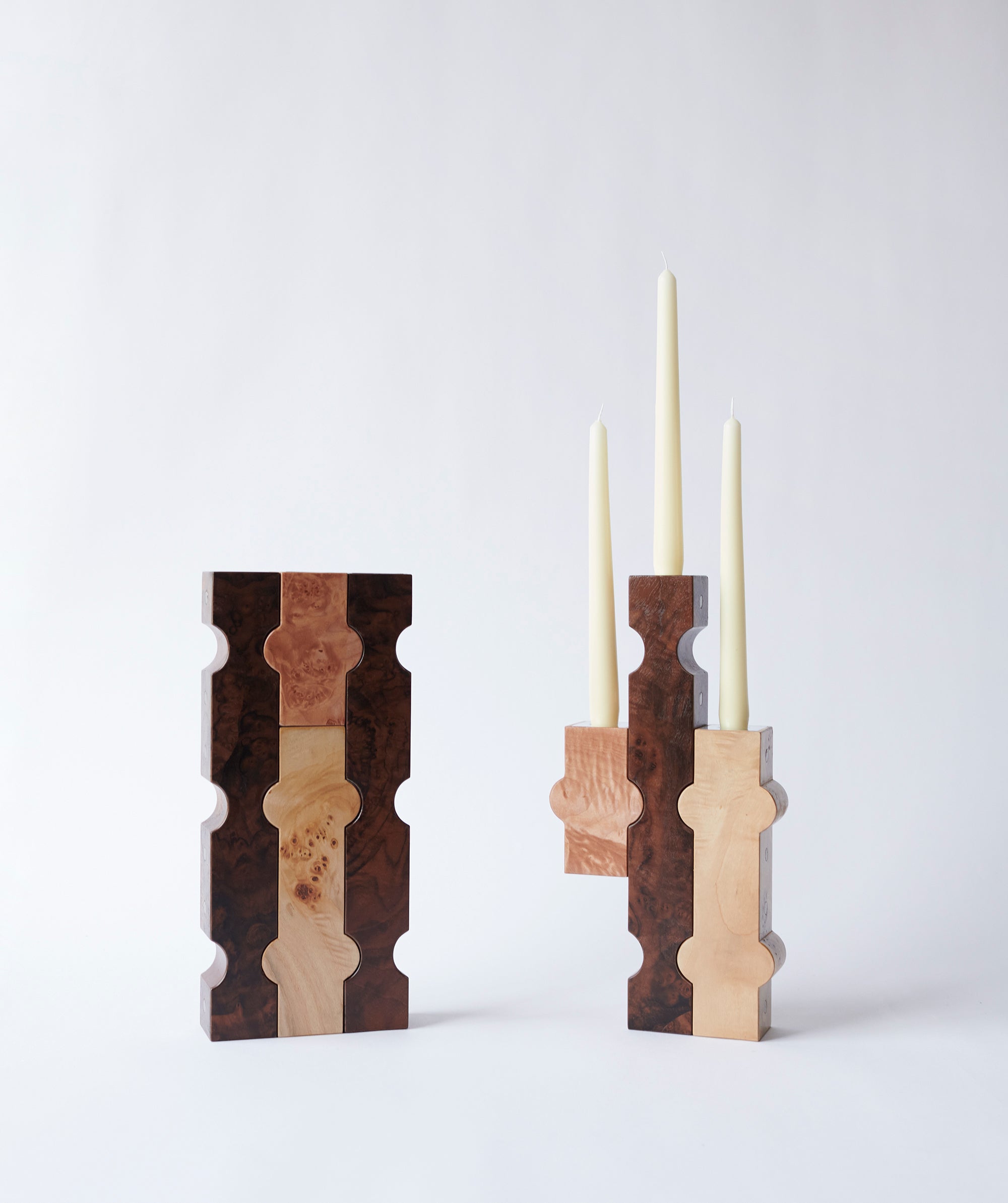 Sculptural wooden candle holders with white taper candles