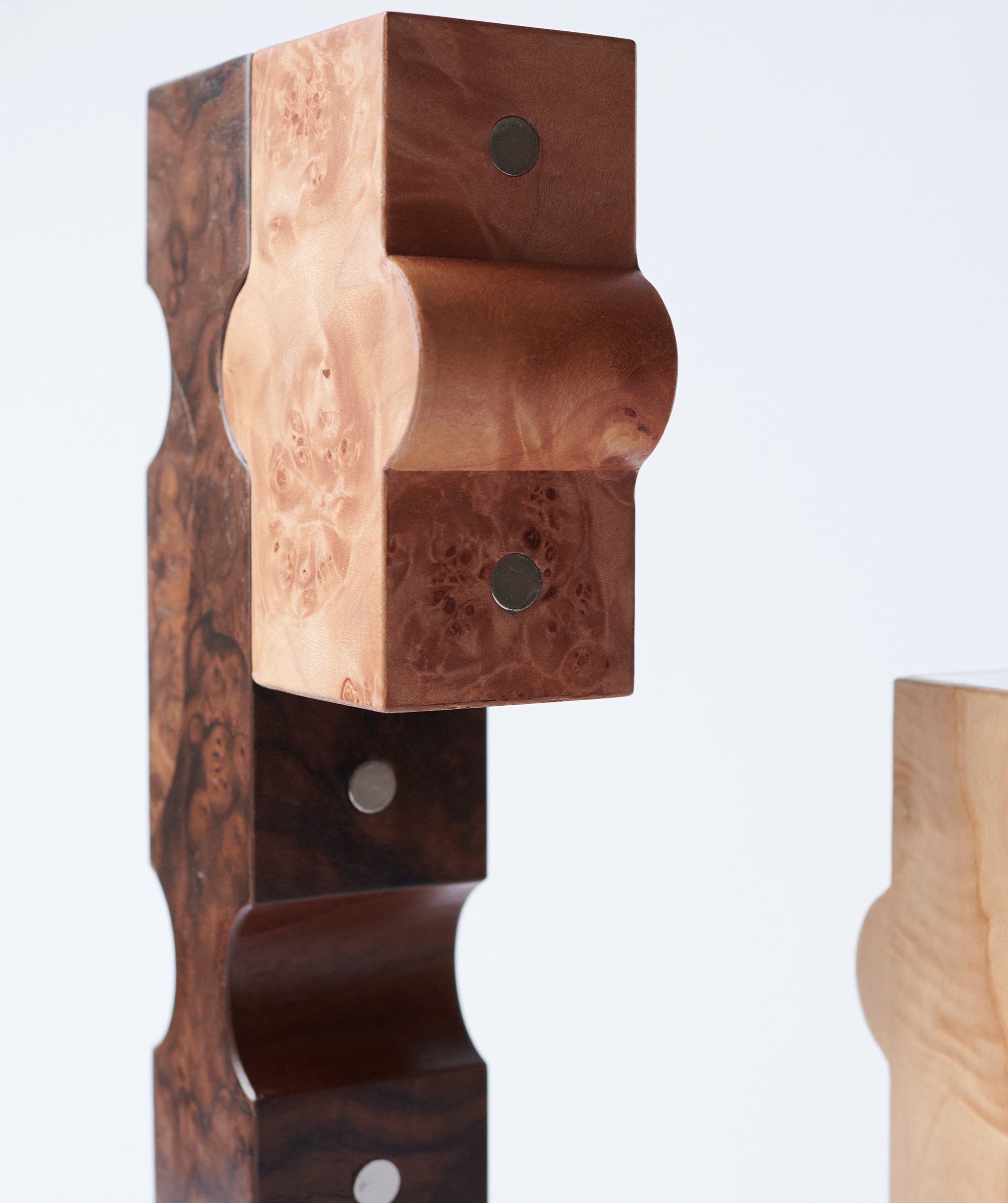 Close up of interlocking candle holder pieces with metal details