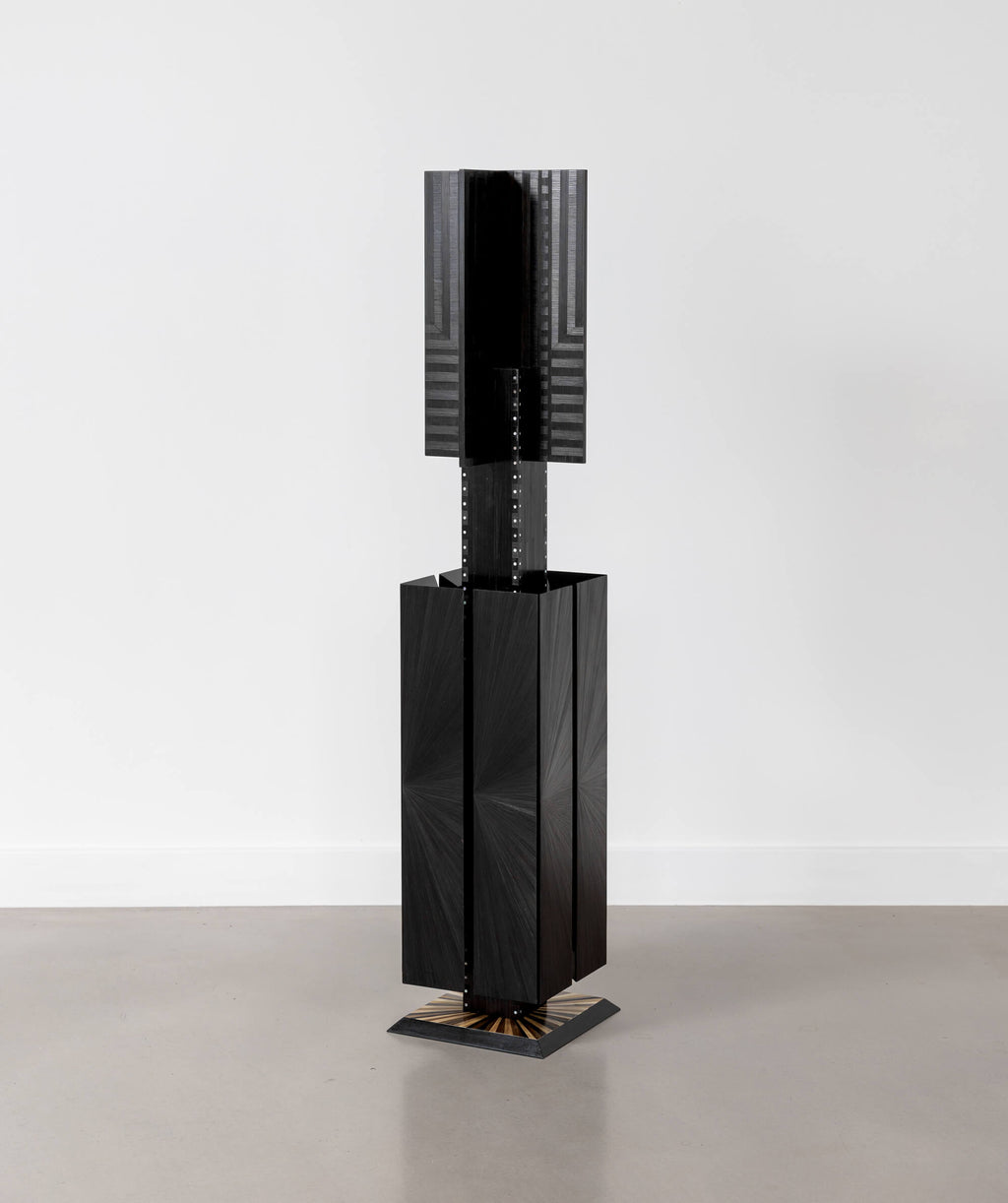 Floor standing geometric sculpture with subtle texture and white details 