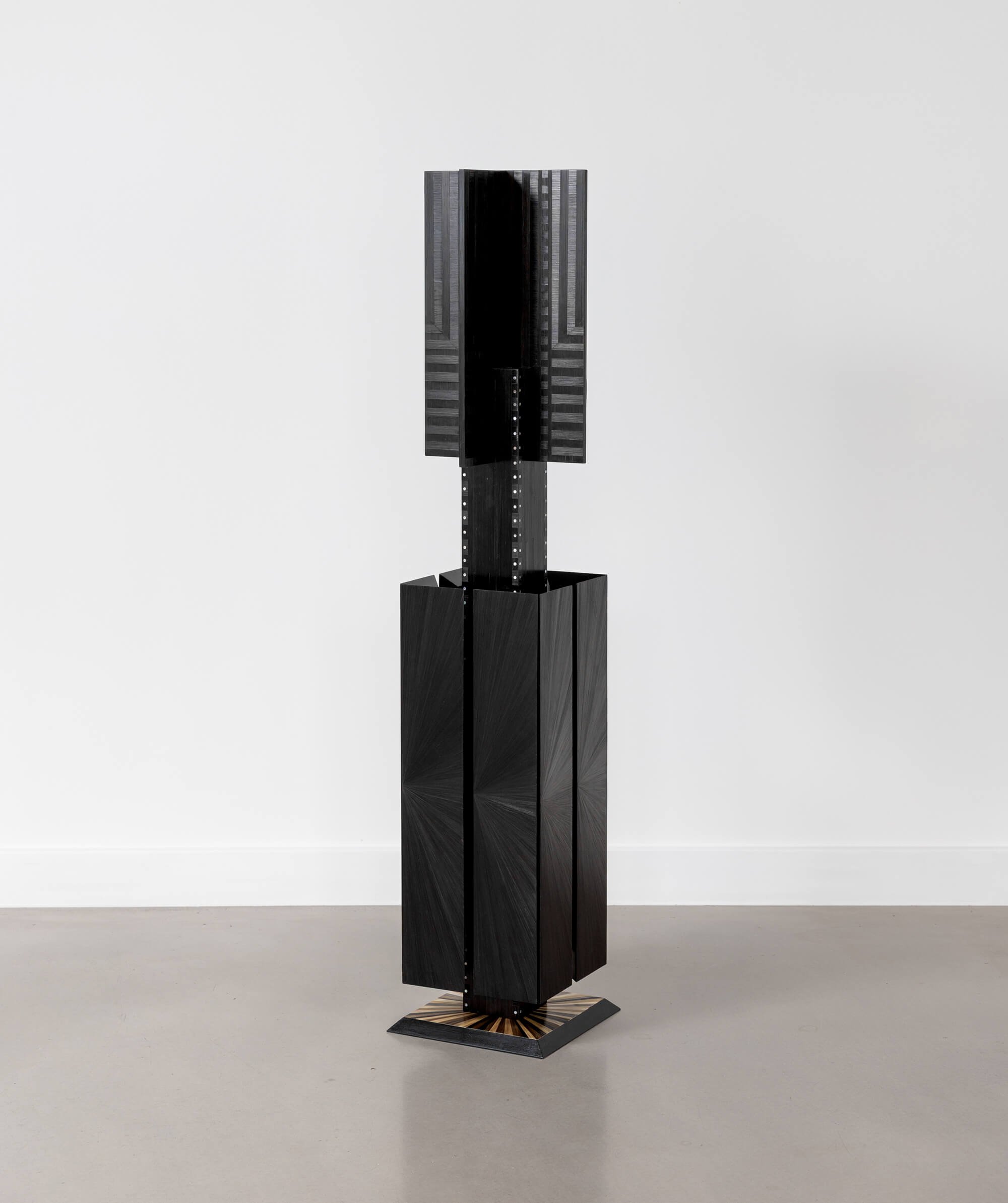Floor standing geometric sculpture with subtle texture and white details 