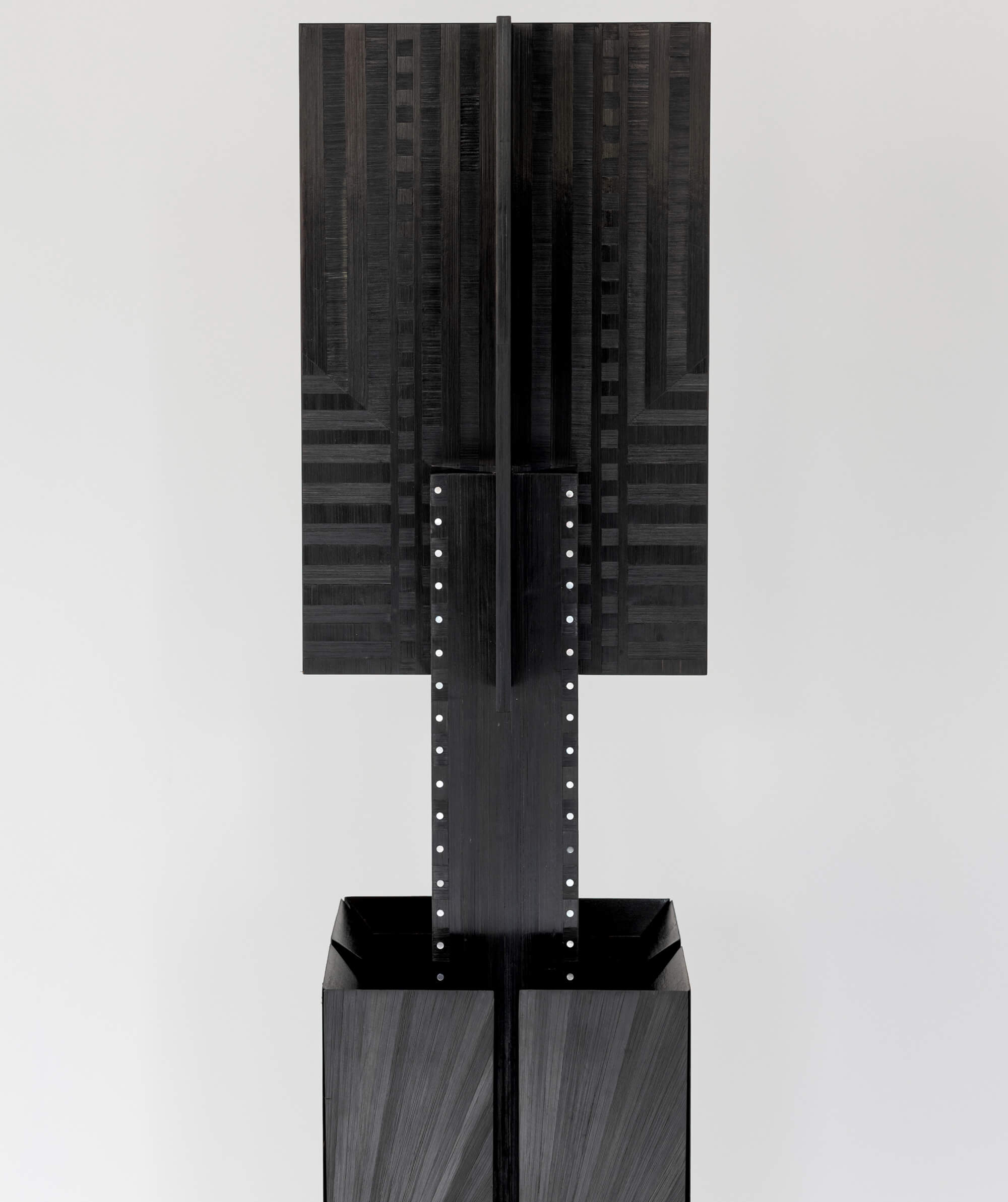 View of the top of a geometric sculpture with subtle texture