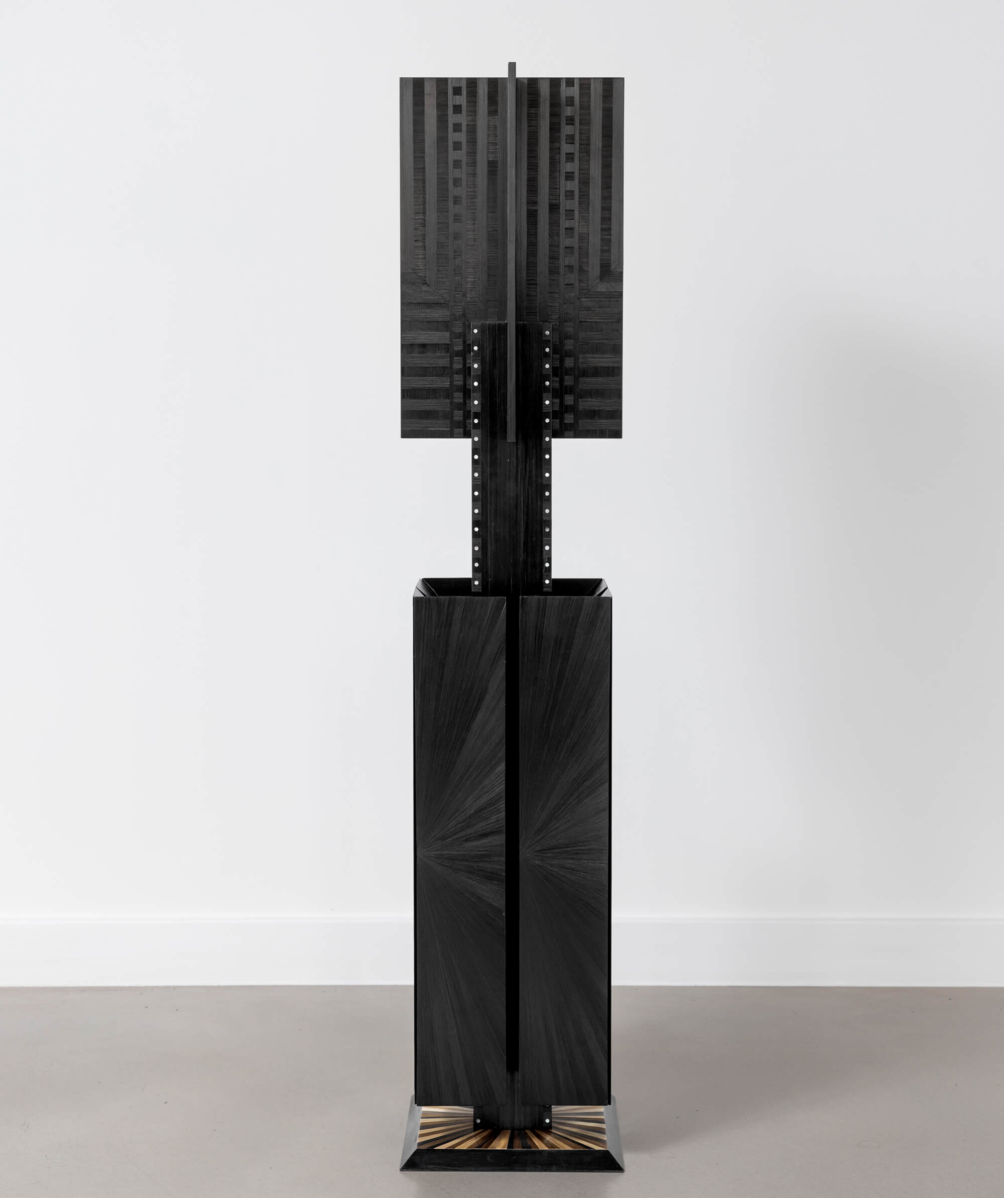 Black geometric sculptural piece with subtle surface texture
