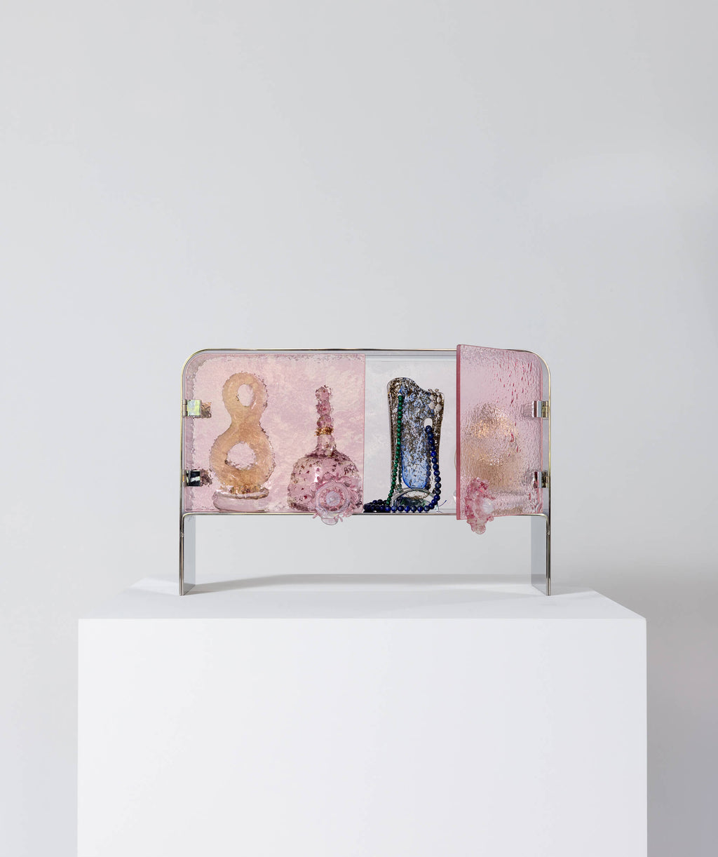 Sculptural cabinet made of pink textured glass and polished steel with door open