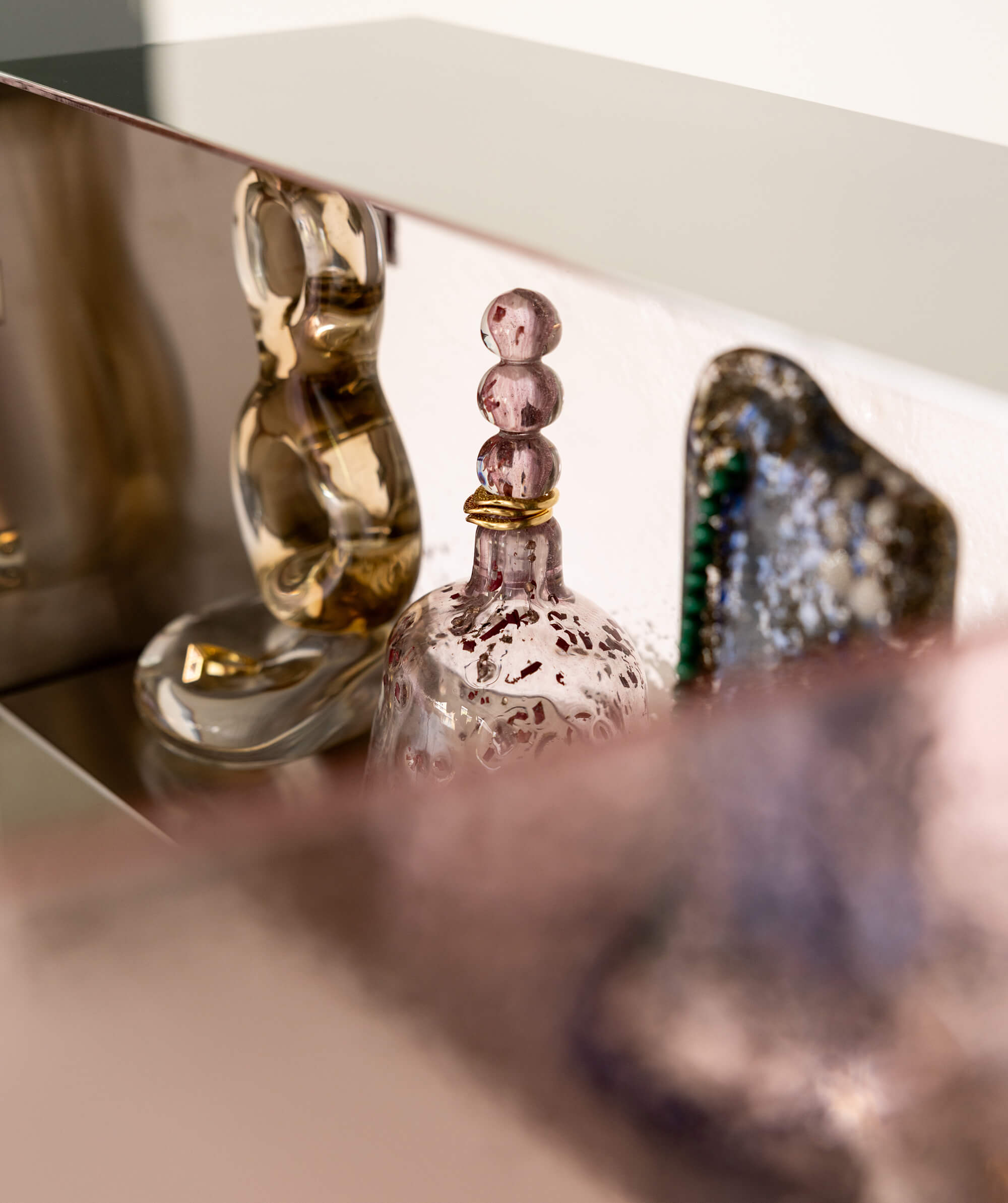 View of sculptural glass objects within the cabinet