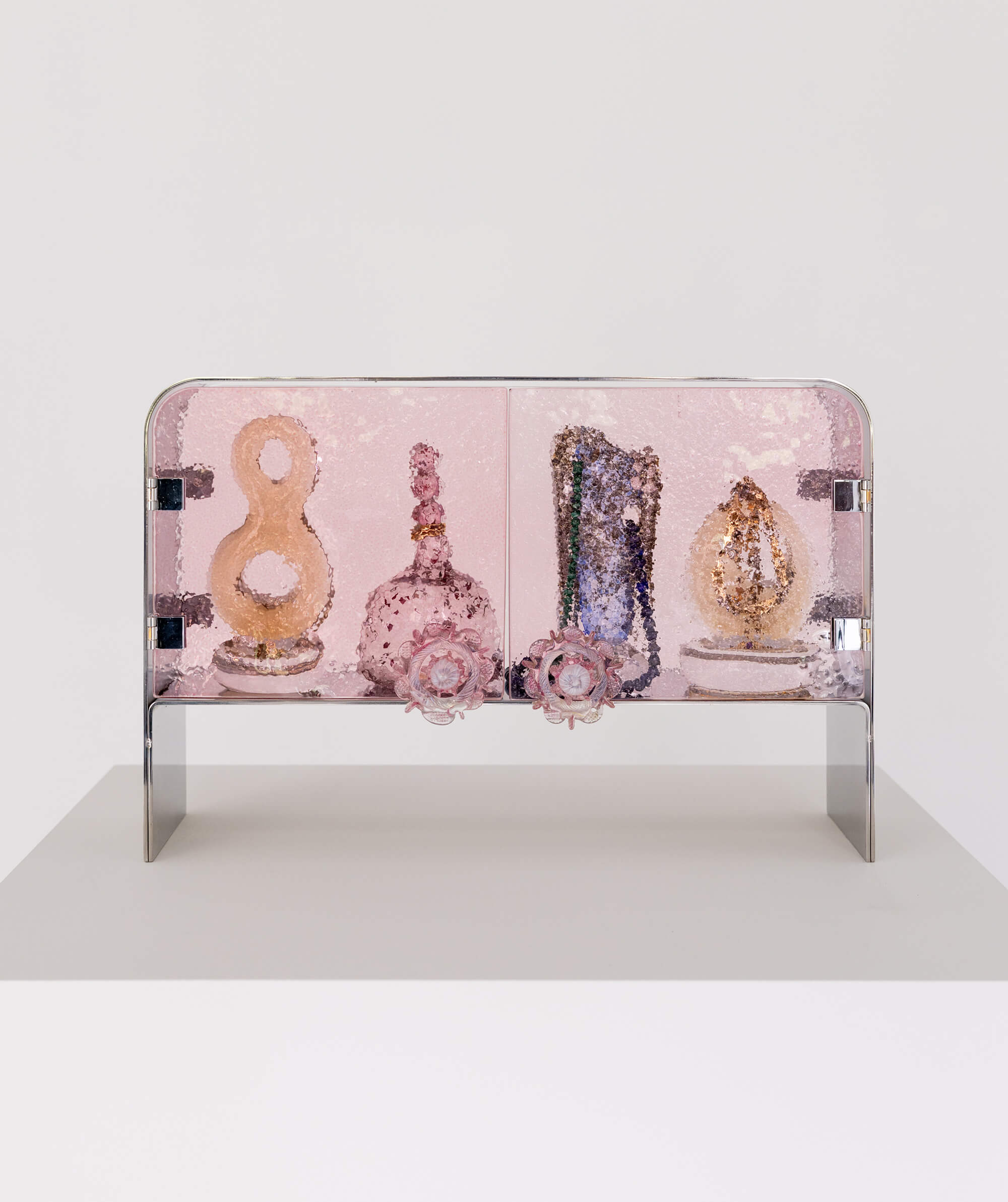 Pink textured glass cabinet with steel frame, designed to house valuables and curiosities