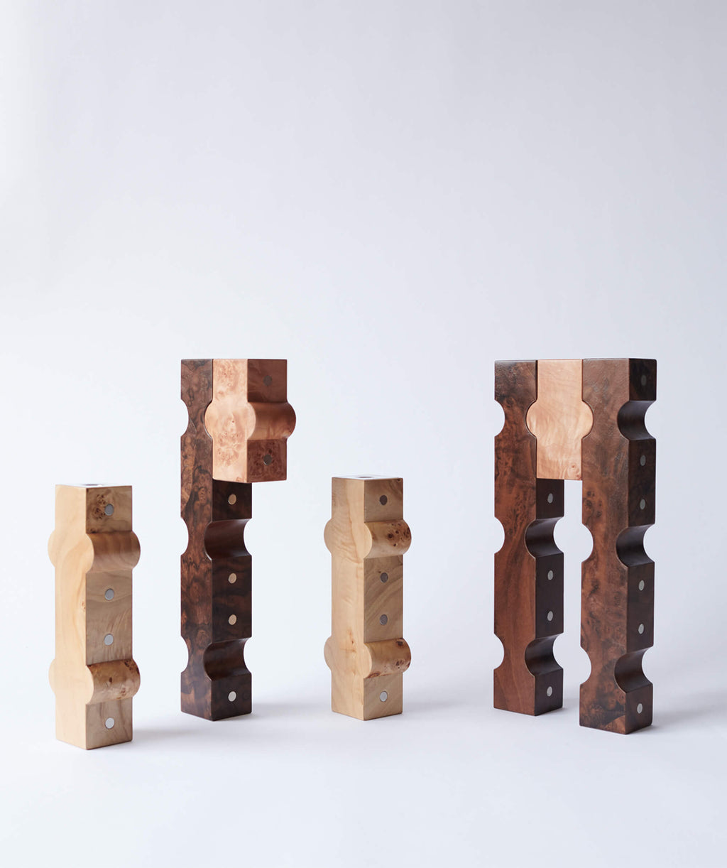 Sculptural wooden candle holders with metal details