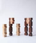 Sculptural wooden candle holders with metal details