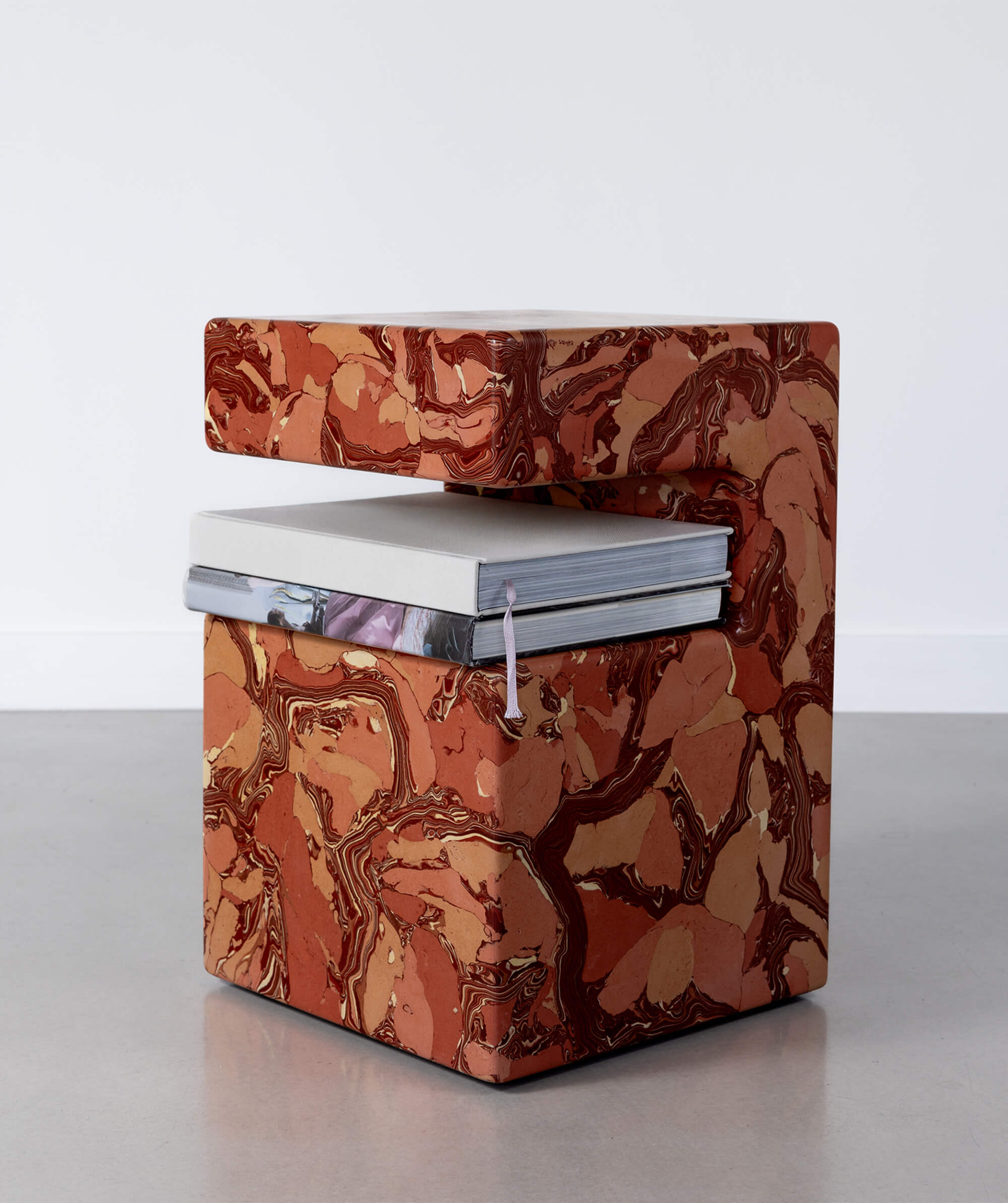 Marble patterned scagliola sculptural table with hard backed books